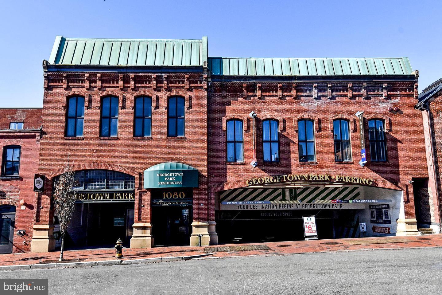 1080 Wisconsin Avenue Northwest, Unit 2001 Washington, DC 20007 - Photo 3 of 30 a front view of a building with retail shops