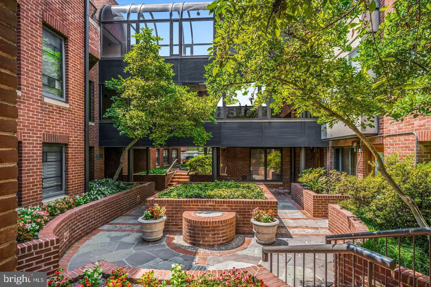 1080 Wisconsin Avenue Northwest, Unit 2001 Washington, DC 20007 - Photo 5 of 30 a front view of house with outdoor seating and green space