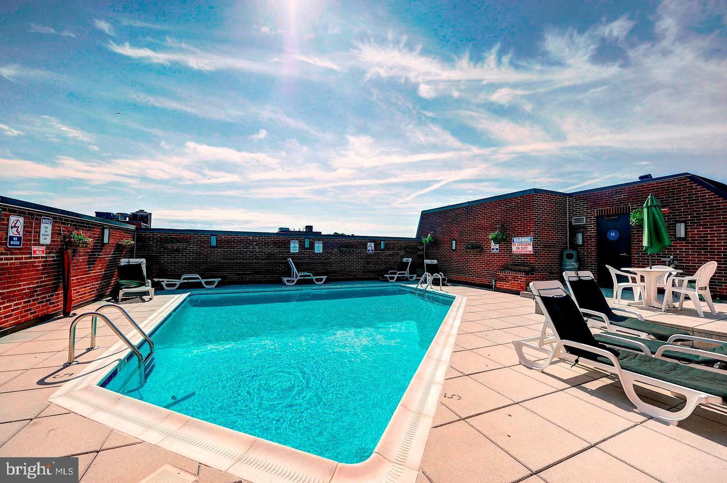1080 Wisconsin Avenue Northwest, Unit 2001 Washington, DC 20007 - Photo 7 of 30 a view of a swimming pool with a lounge chairs