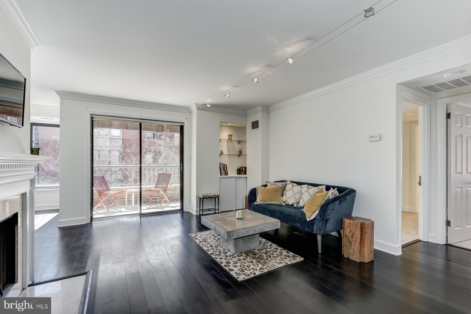 1080 Wisconsin Avenue Northwest, Unit 2001 Washington, DC 20007 - Photo 30 of 30 a living room with furniture and wooden floor