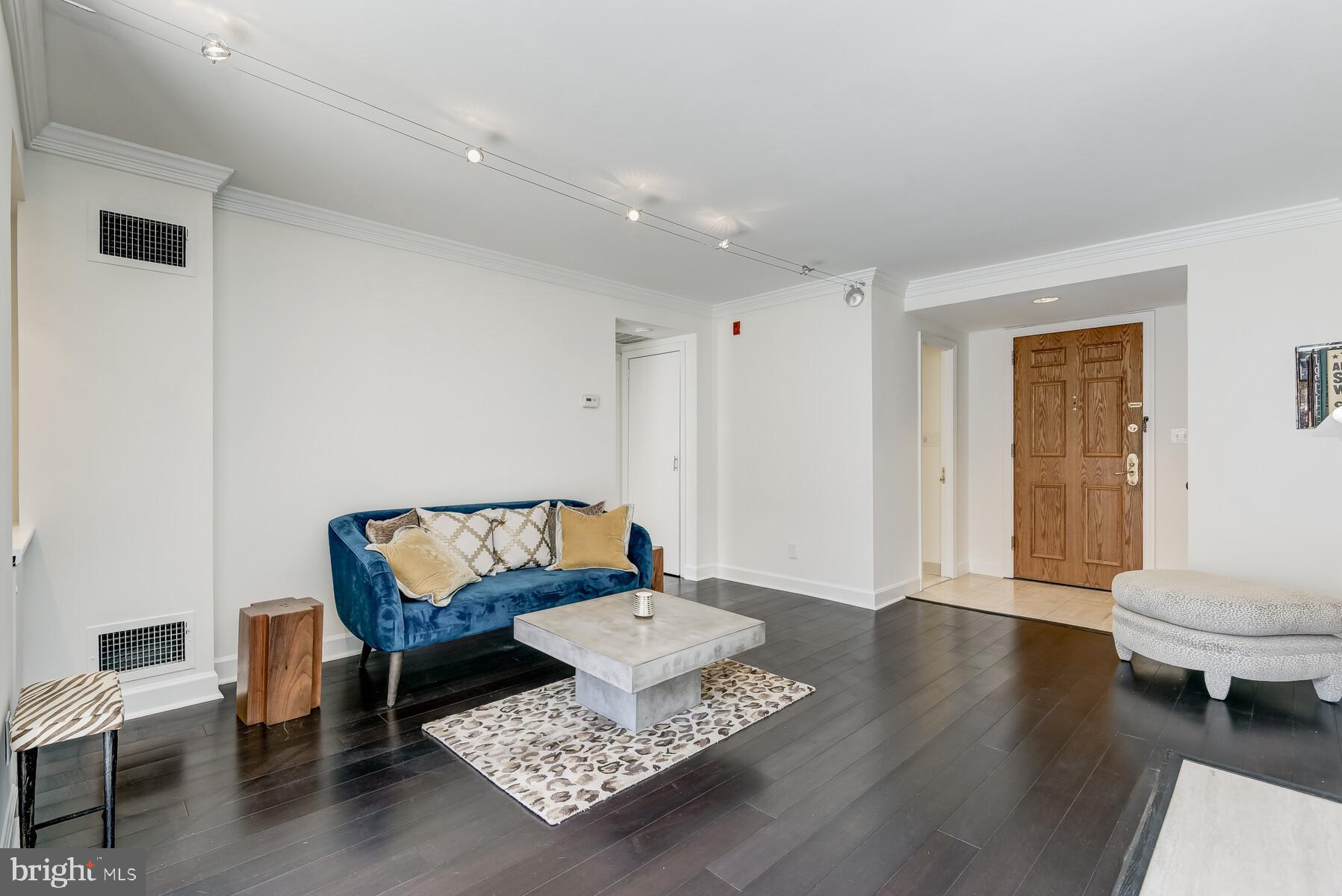 1080 Wisconsin Avenue Northwest, Unit 2001 Washington, DC 20007 - Photo 9 of 30 a living room with a couch and a table