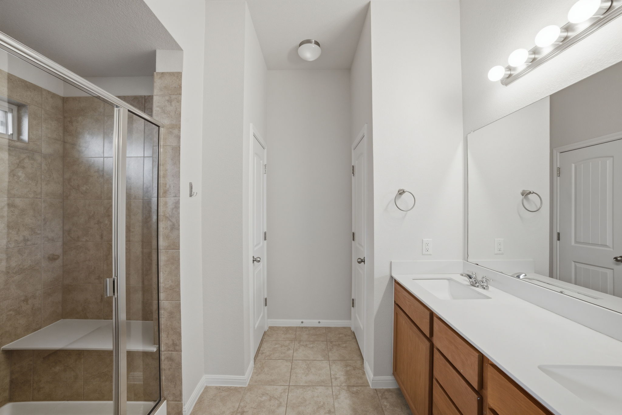 514 Nautical Loop Kyle, TX 78640 - Photo 13 of 24 A clean, modern bathroom offers a spacious double vanity and a glass-enclosed shower.
