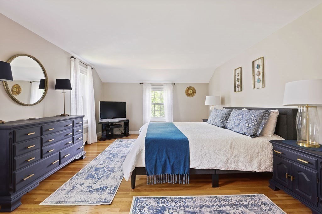 28 Appleton Road Needham, MA 02492 - Photo 13 of 24 a bedroom with a large bed and a flat screen tv