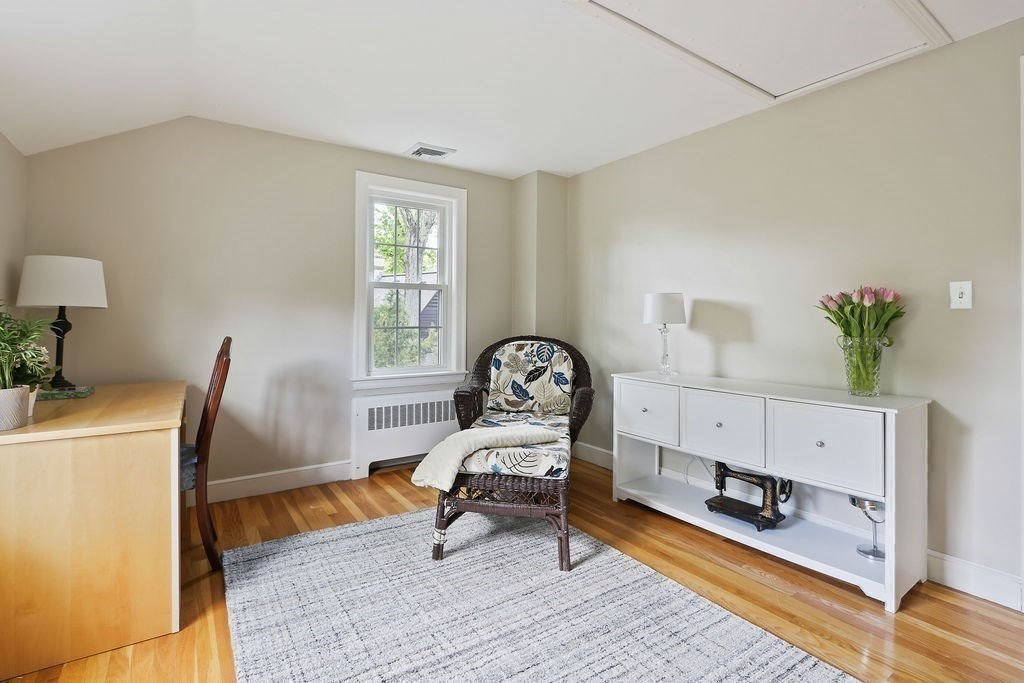 28 Appleton Road Needham, MA 02492 - Photo 15 of 24 a living room with furniture and a potted plant on a dresser