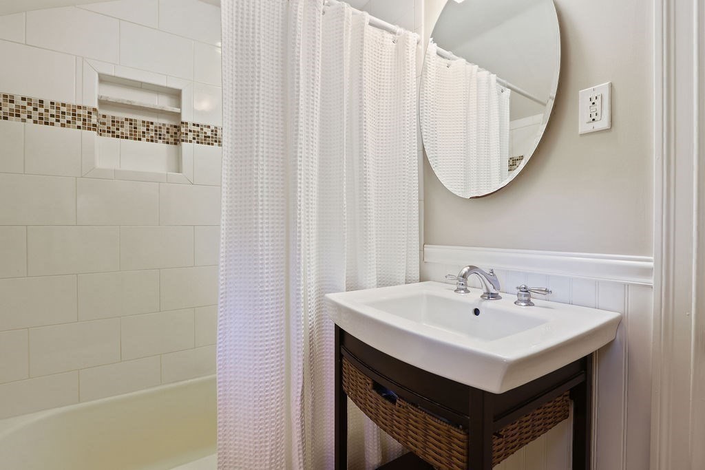 28 Appleton Road Needham, MA 02492 - Photo 16 of 24 a bathroom with a sink a mirror and a shower