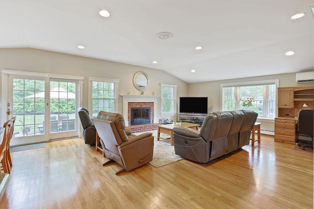 28 Appleton Road Needham, MA 02492 - Photo 3 of 24 a living room with furniture flat screen tv and a fireplace