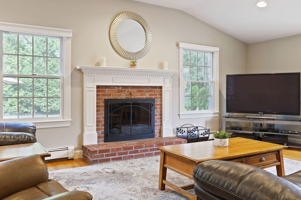 28 Appleton Road Needham, MA 02492 - Photo 4 of 24 a living room with furniture a flat screen tv and a fireplace