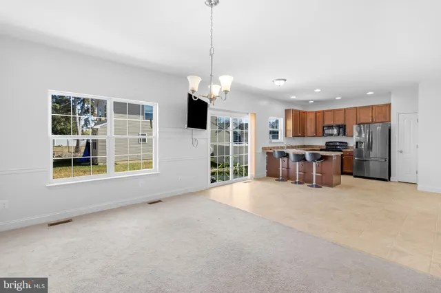 a view of kitchen with refrigerator and window