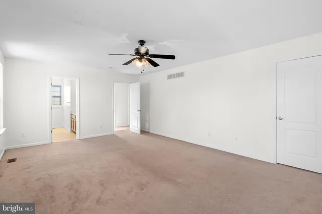 a view of room with a ceiling fan