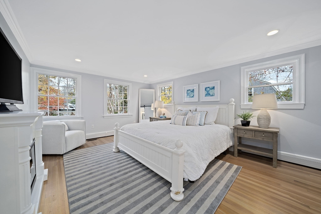 309 South Main Street Cohasset, MA 02025 - Photo 18 of 35 a spacious bedroom with a large bed and a couch