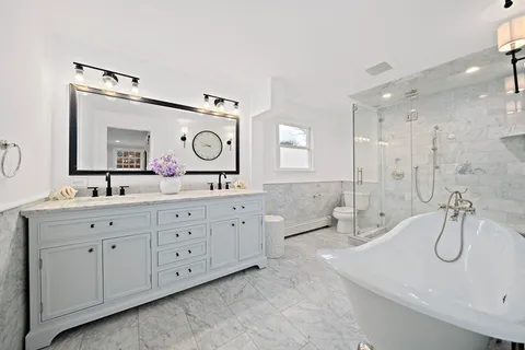 a spacious bathroom with double sink and a mirror