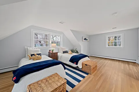 a bedroom with furniture and a window