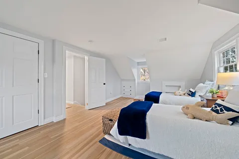 a bedroom with bed and window