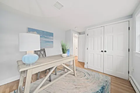 a view of a dining room with furniture and wooden floor