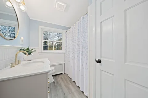 a bathroom with a sink toilet and shower