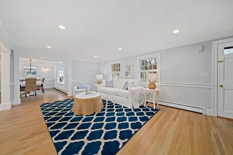 a living room with a couch and wooden floor