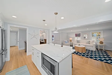 a open kitchen with stainless steel appliances granite countertop a stove and a refrigerator