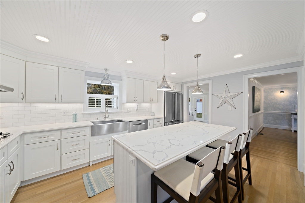 309 South Main Street Cohasset, MA 02025 - Photo 8 of 35 a kitchen with a table chairs refrigerator and cabinets