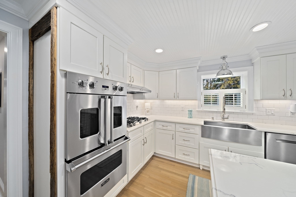 309 South Main Street Cohasset, MA 02025 - Photo 10 of 35 a kitchen with white cabinets and white appliances