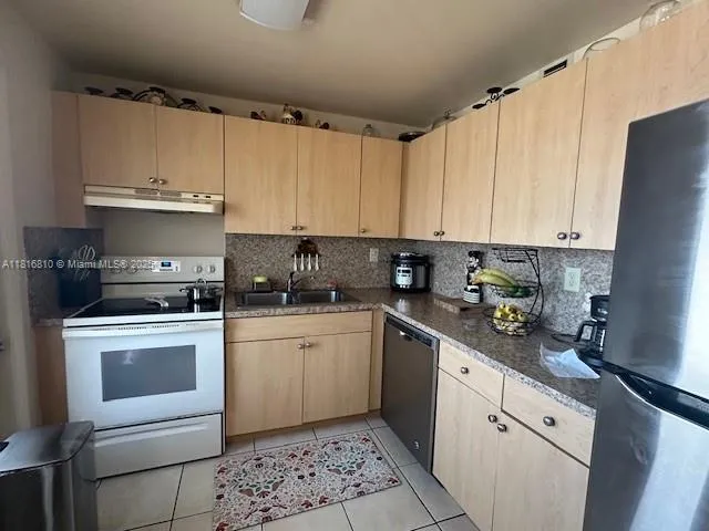 a kitchen with a white cabinets and white appliances