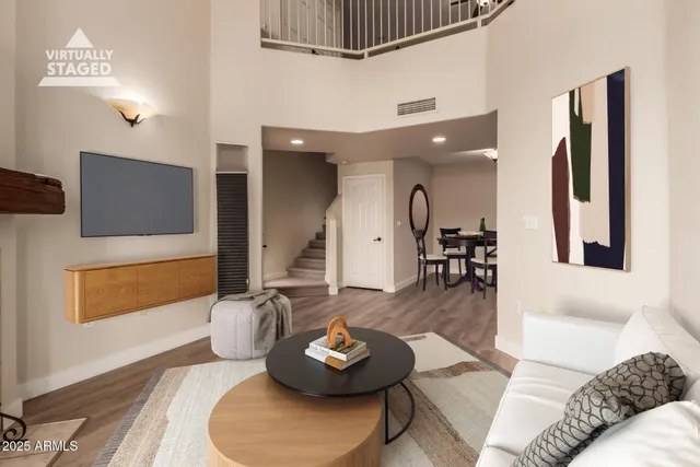 a living room with furniture and a wooden floor