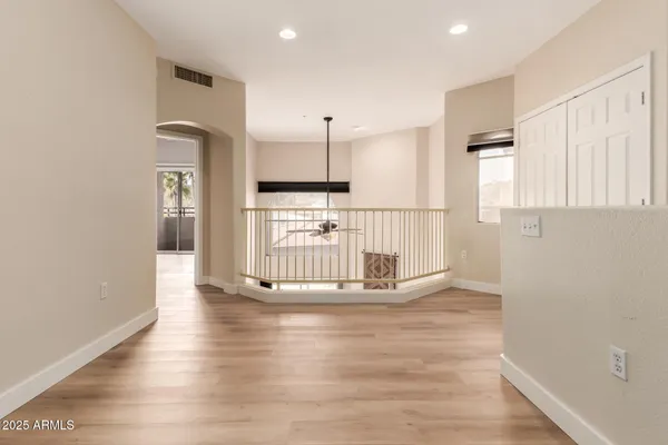 a view of empty room with wooden floor