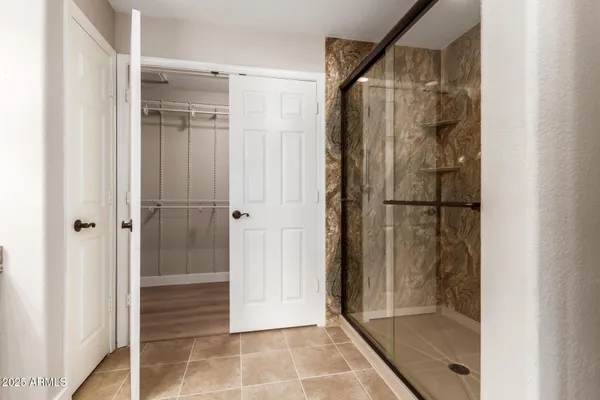 a bathroom with a glass shower door