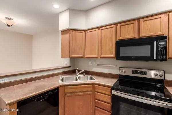 a kitchen with a sink stove and microwave
