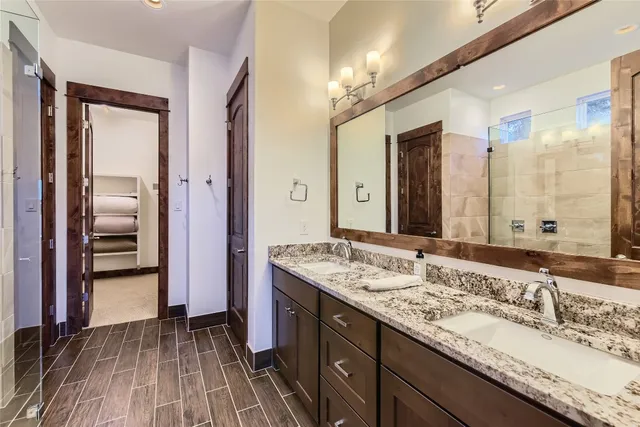 a bathroom with a granite countertop sink mirror and double
