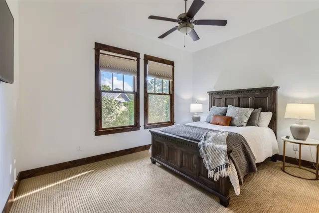 a bed sitting in a bedroom next to a window
