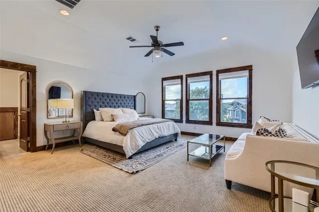 a bedroom with a bed chair and window