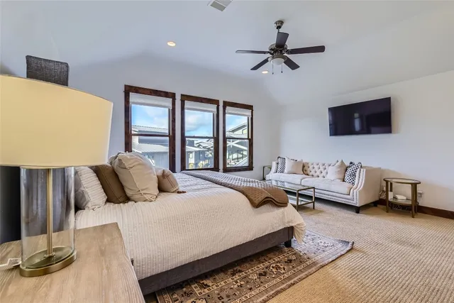 a bedroom with a bed couch and a window