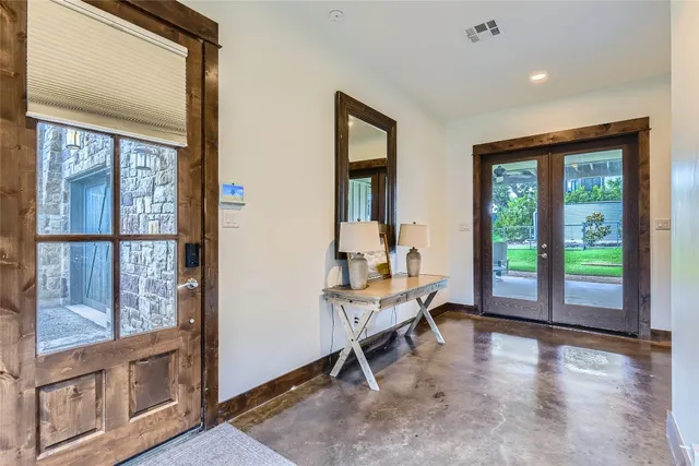 a view of a livingroom with wooden floor and furniture
