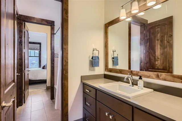 a en suite bathroom with a sink a mirror and a bathtub