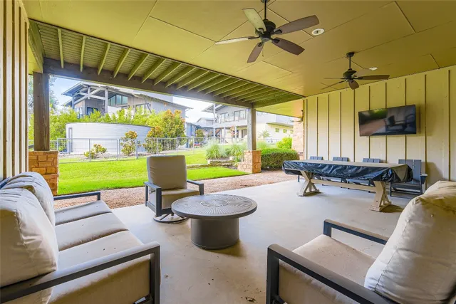 a living room with patio furniture and a fireplace