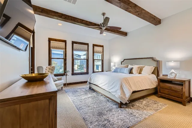 a bedroom with a bed a mirror and a window