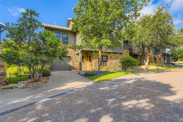 a view of road with house and trees in the background