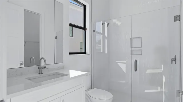 a bathroom with a sink toilet and shower