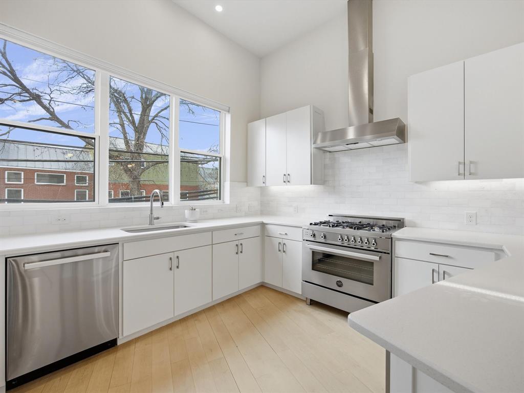2802 Lee Street Dallas, TX 75206 - Photo 13 of 40 a kitchen with stainless steel appliances granite countertop a stove and a sink