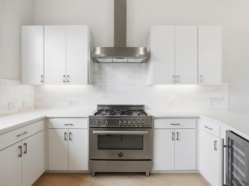 2802 Lee Street Dallas, TX 75206 - Photo 14 of 40 a kitchen with granite countertop white cabinets and white stove