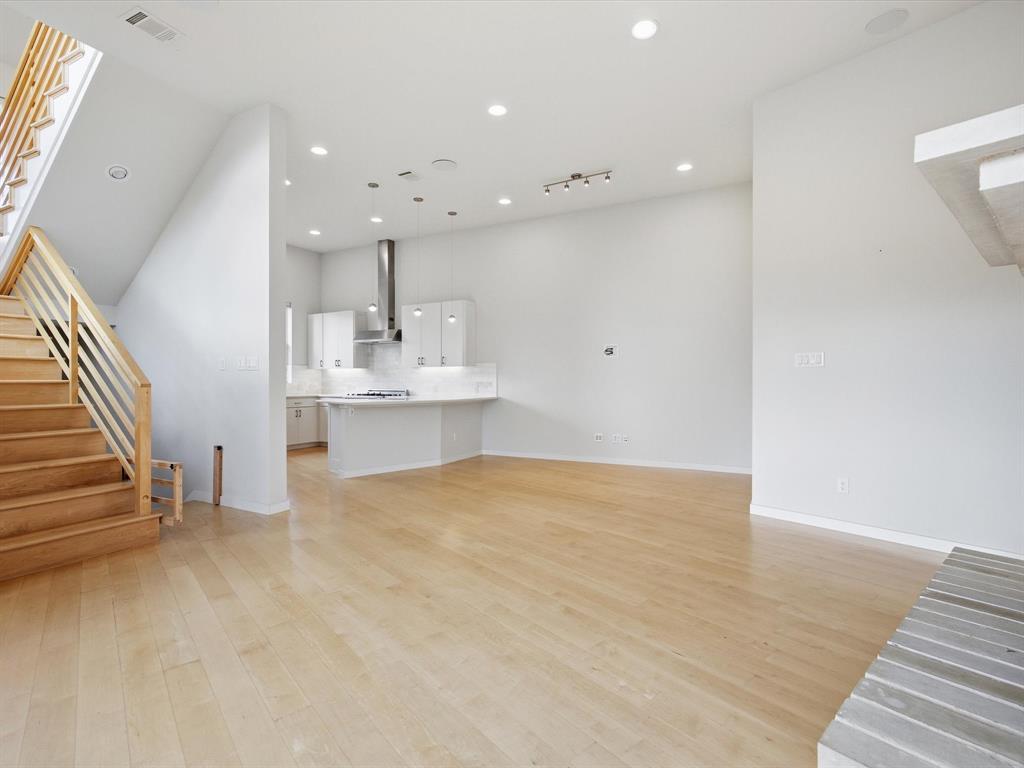 2802 Lee Street Dallas, TX 75206 - Photo 15 of 40 an empty room with wooden floor and windows