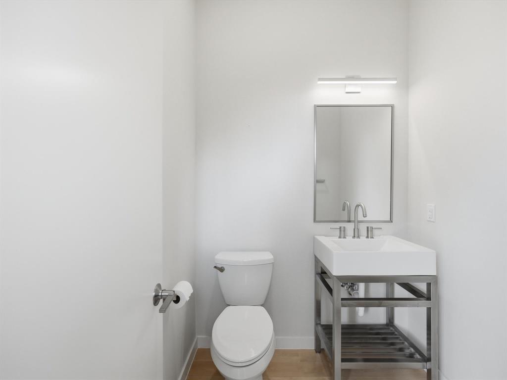 2802 Lee Street Dallas, TX 75206 - Photo 16 of 40 a bathroom with a toilet a sink and mirror