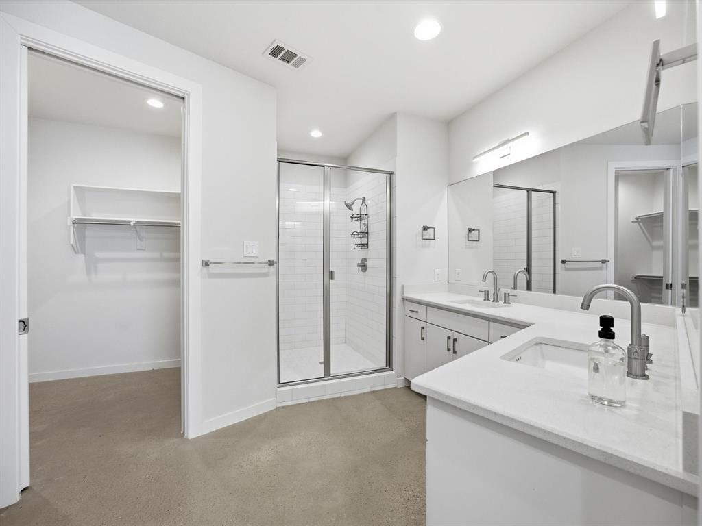 2802 Lee Street Dallas, TX 75206 - Photo 19 of 40 a bathroom with a shower sink vanity and mirror