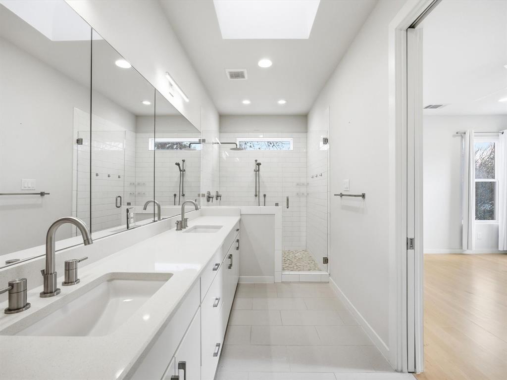 2802 Lee Street Dallas, TX 75206 - Photo 22 of 40 a bathroom with a sink tub and a mirror