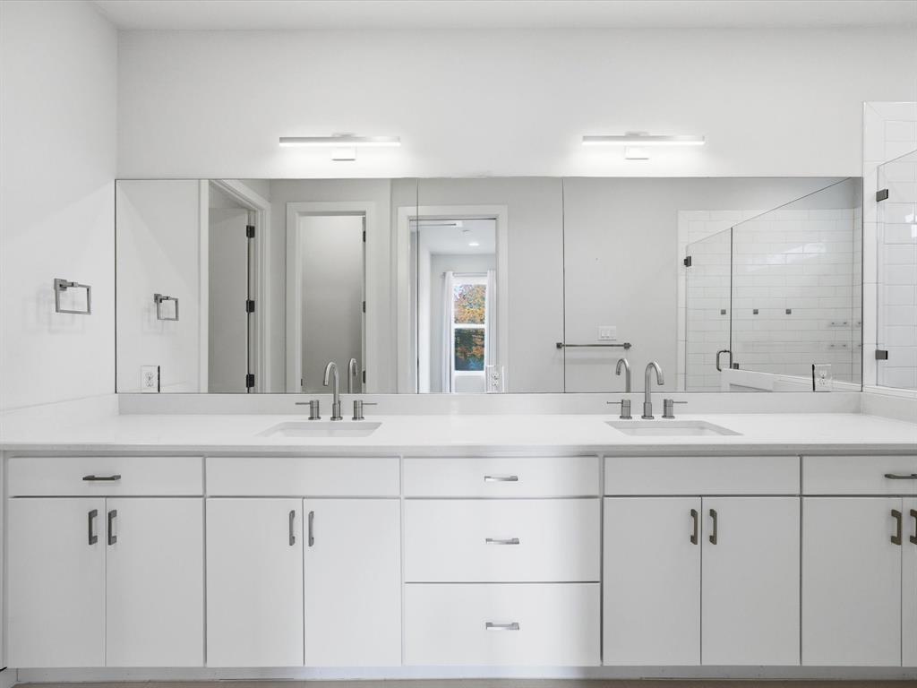 2802 Lee Street Dallas, TX 75206 - Photo 23 of 40 a bathroom with double sink and a mirror
