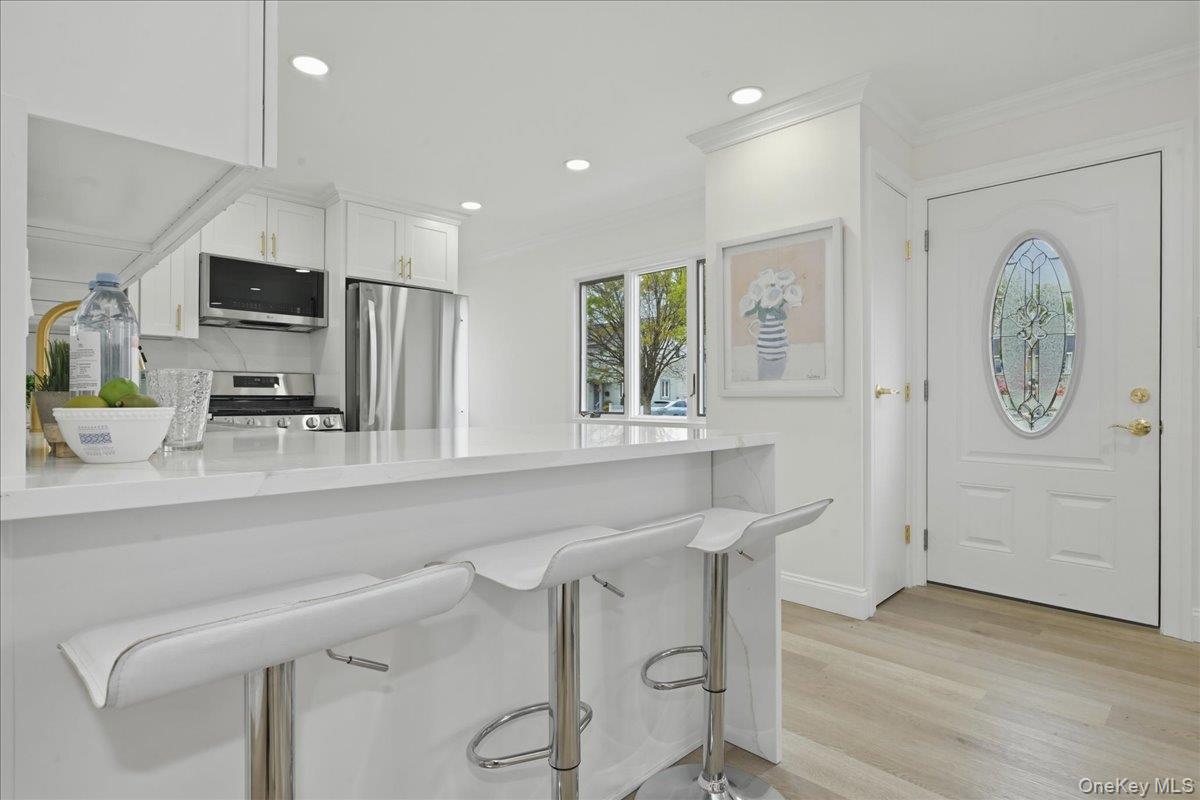 84 North Fordham Road Hicksville, NY 11801 - Photo 6 of 28 a kitchen with stainless steel appliances granite countertop a sink and a refrigerator