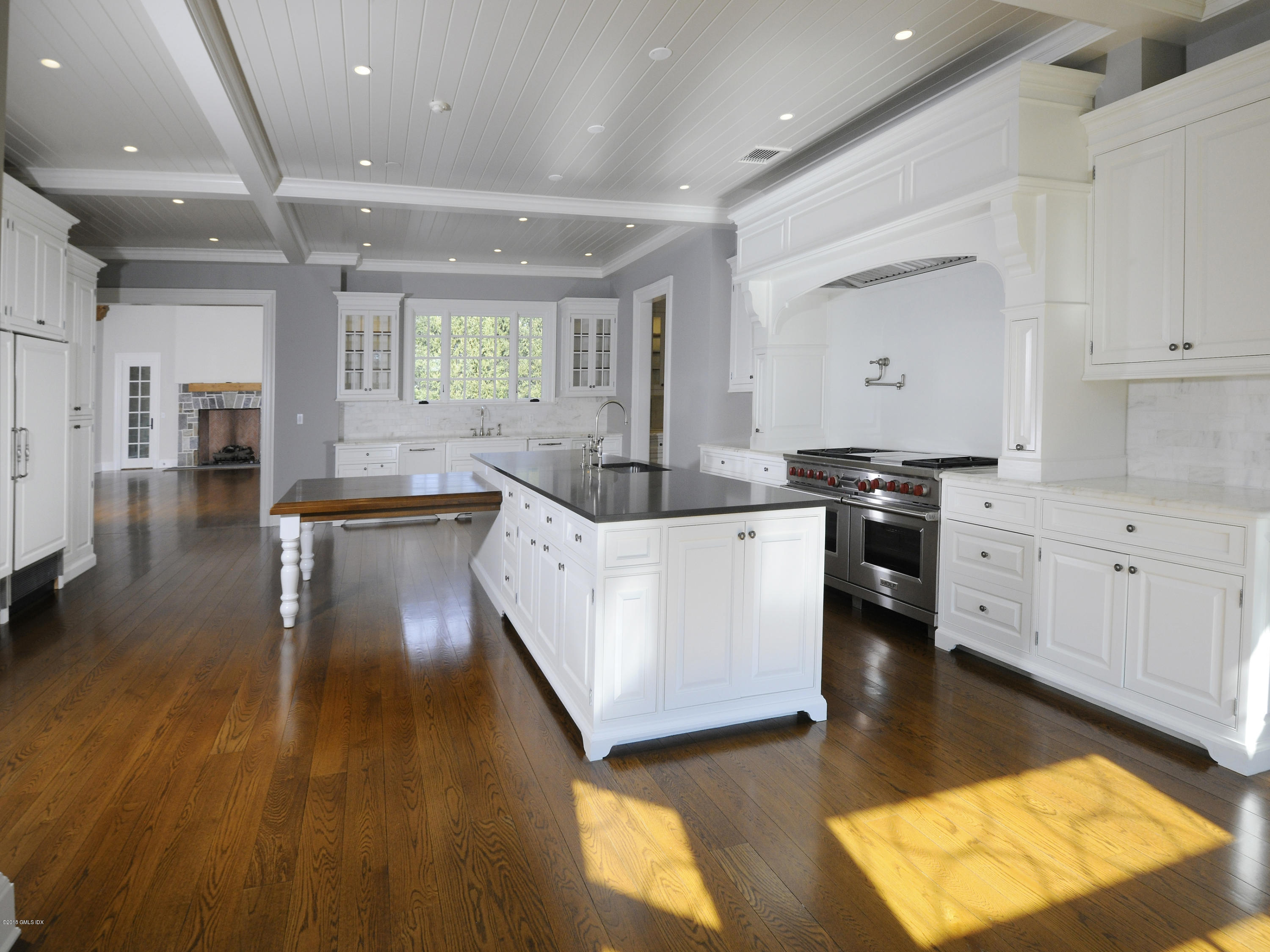 2 Deer Park Meadow Road Greenwich, CT 06830 - Photo 11 of 28 a kitchen with stainless steel appliances kitchen island granite countertop a stove a sink and a refrigerator