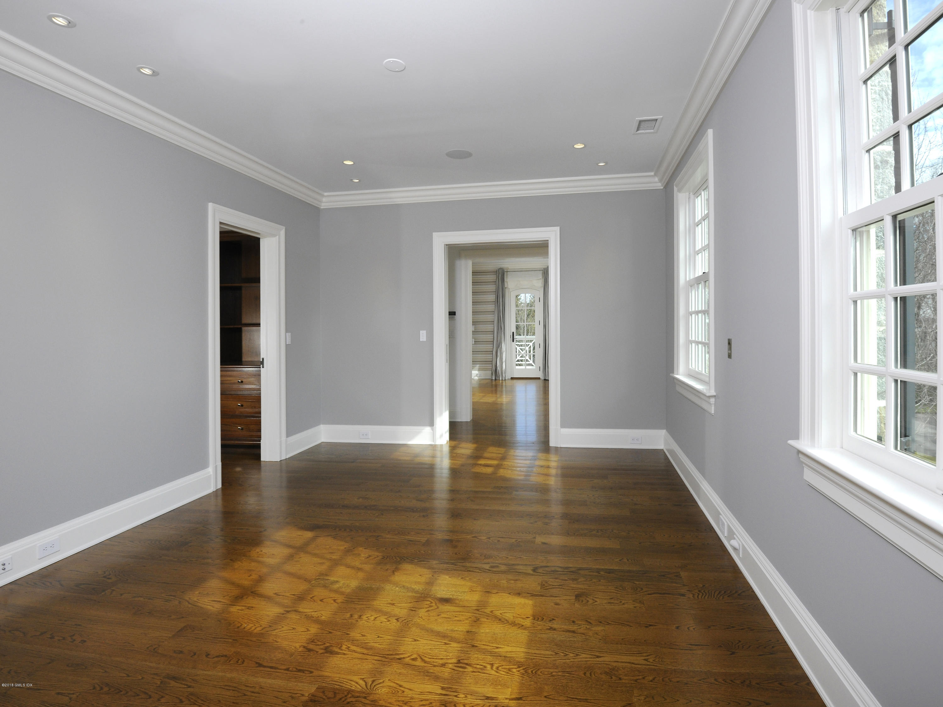2 Deer Park Meadow Road Greenwich, CT 06830 - Photo 16 of 28 an empty room with wooden floor and windows