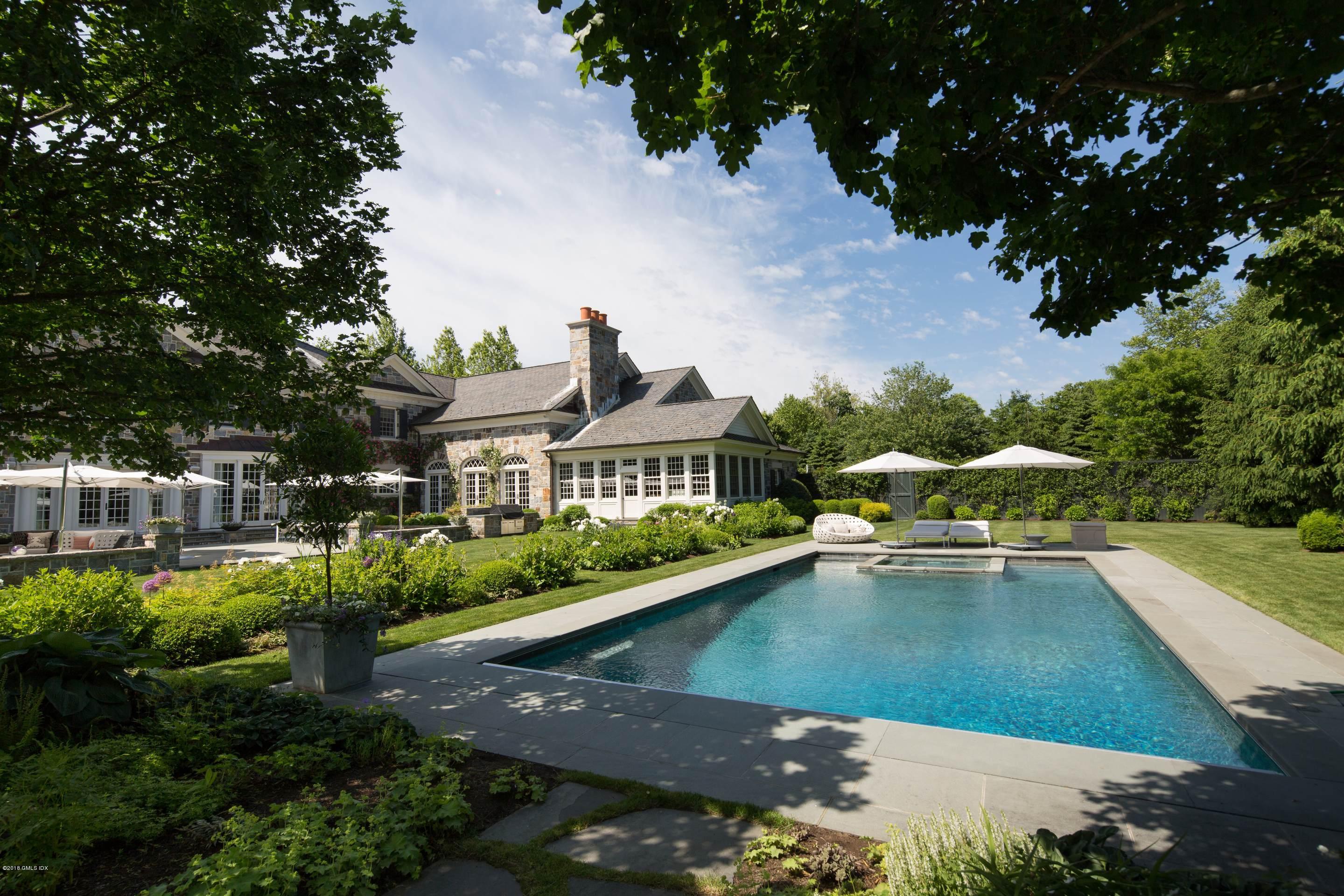 2 Deer Park Meadow Road Greenwich, CT 06830 - Photo 25 of 28 a view of a house with pool and chairs