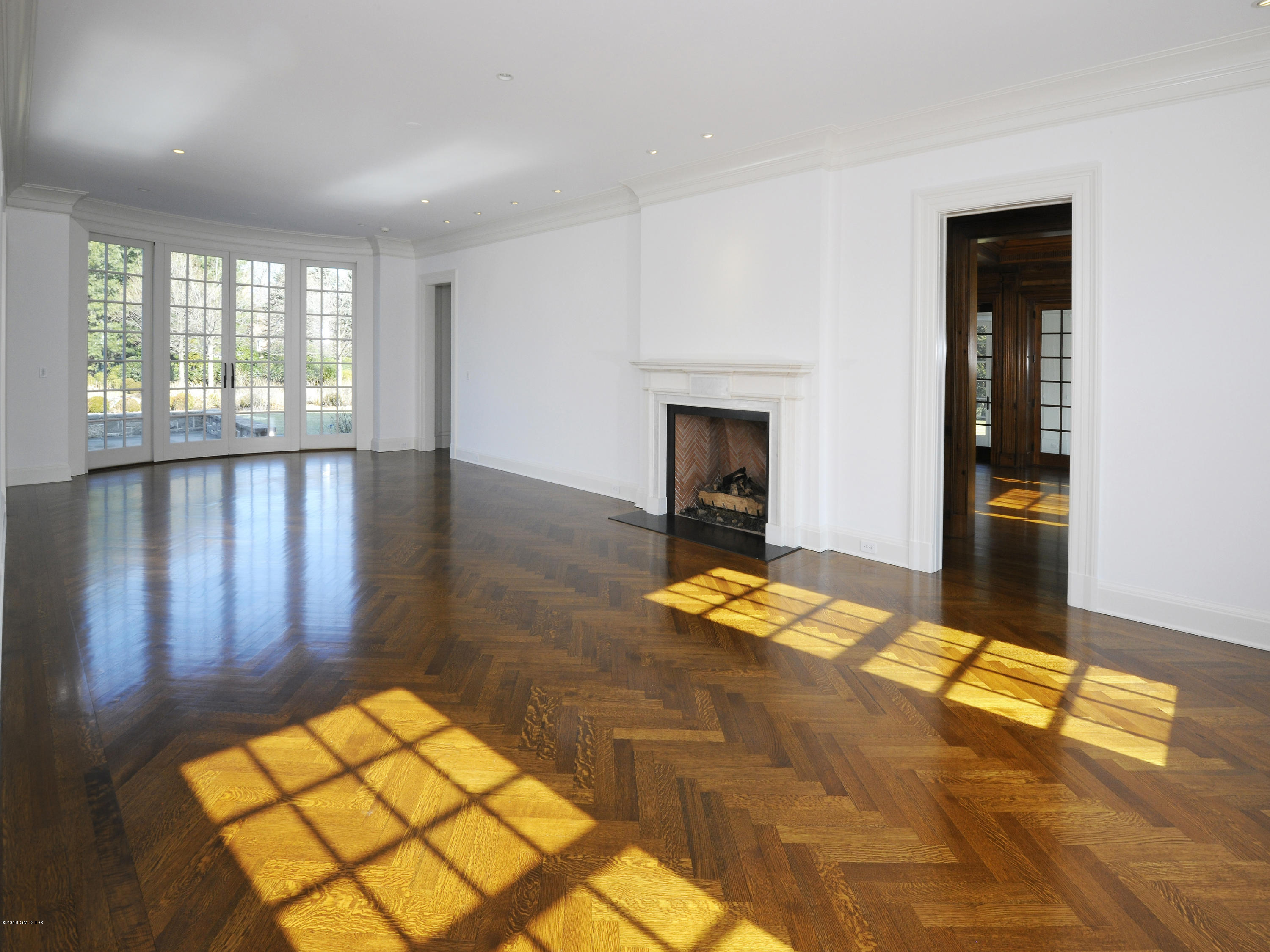 2 Deer Park Meadow Road Greenwich, CT 06830 - Photo 5 of 28 a view of a livingroom with wooden floor and a fireplace